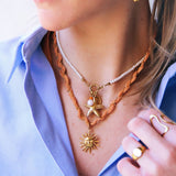 Pearl necklace with sun and cluster of gemstones