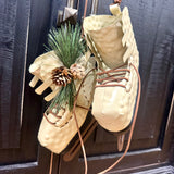 Pair of Ice Skates with Pine Cones