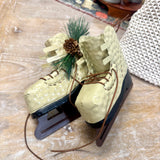 Pair of Ice Skates with Pine Cones