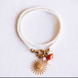 Pearl necklace with sun and cluster of gemstones